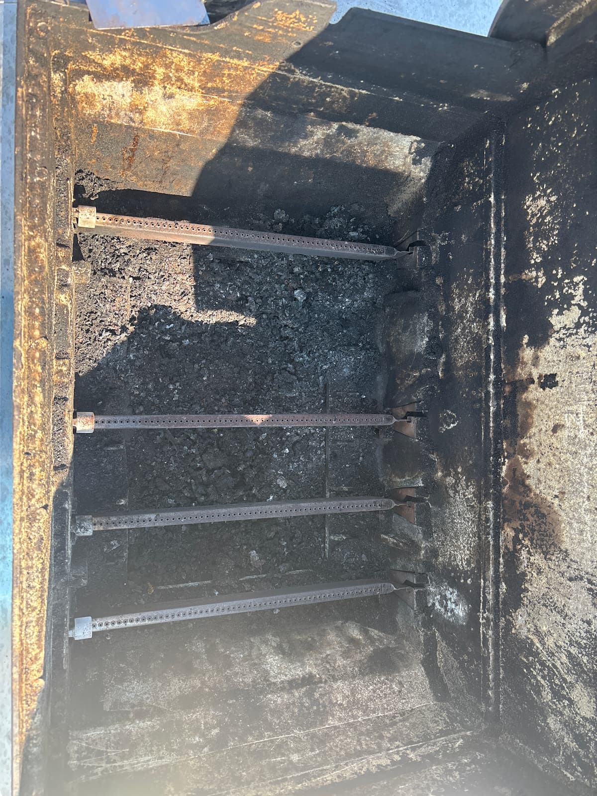 Corroded grill burners before cleaning